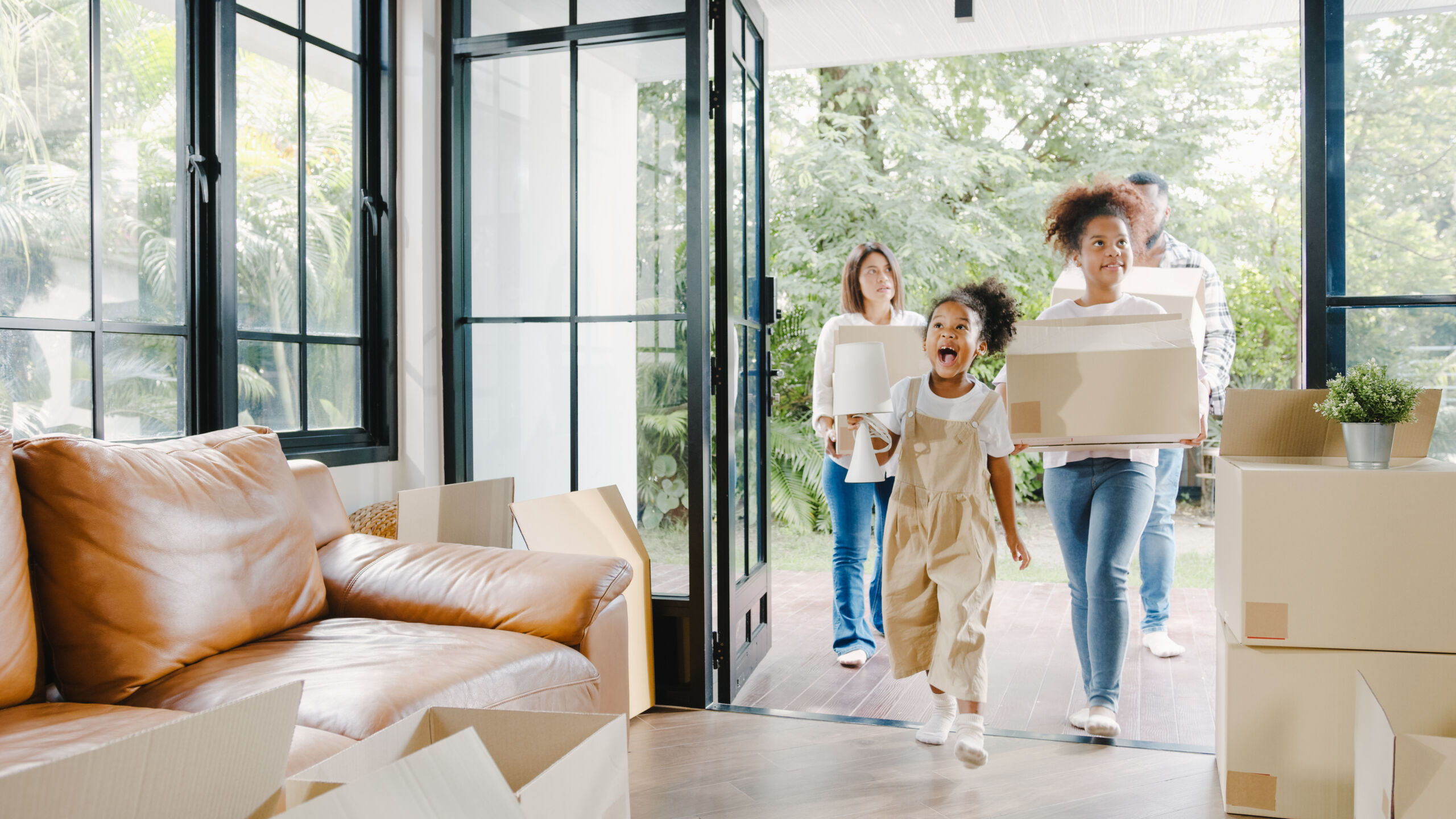 Happy African American young family bought new house. Mom, Dad,